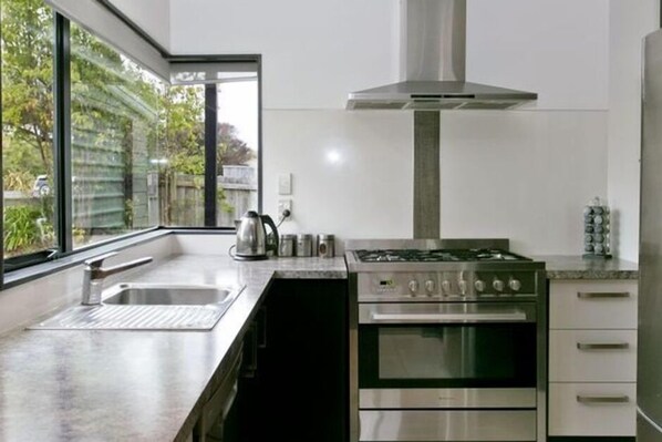 Modern kitchen, fully equipped with dishes, cutlery, pots and pans etc