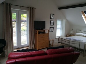 French windows out to a massive furnished decking balcony over the gardens. 