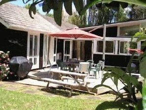 Large sundrenched deck with SHADEMASTER umbrella.