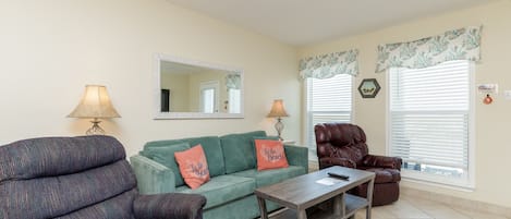 Living area with full size sleeper sofa and comfy recliners