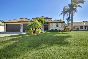 The front of the home with 3 car garage and large driveway