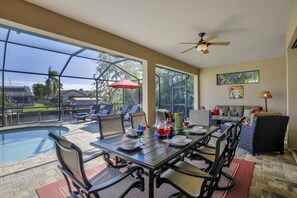 The large outdoor lanai with dining area for 6 plus outside living room.  There is also cable TV on the lanai for extra entertainment