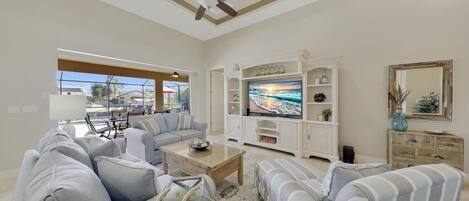 The bright and modern Living area has been decorated in cool beach themed tones