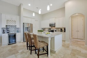 The open plan Kitchen with island is fully equipped with all appliances including wine cooler