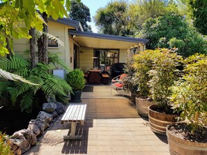 Entrance way to cottage, walking past fishpond