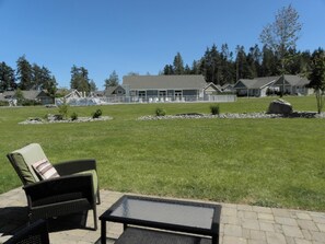 View from rear doors, opening on to patio, lawn, clubhouse and pool.