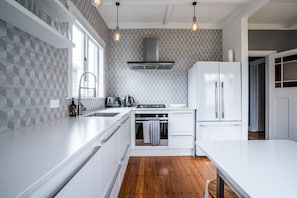 One Fyfe kitchen with built in dishdrawers, a nespresso, nutribullet and microwave