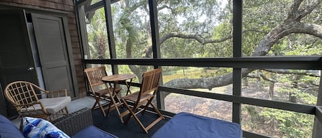 Comfortable seating to enjoy the screened porch overlooking the lagoon.