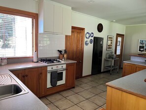 Large open plan kitchen - oven, gas hob, dishwasher, fridge/freezer & microwave.