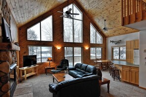 Main level living room with open concept with ceiling fans.