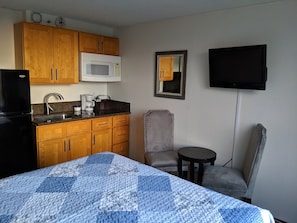 Small kitchen in studio with single burner cooktop.