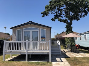 Caravan for hire with decking at Hopton Holiday Village