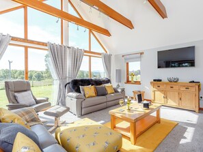 Stylishly furnished living room with wood burner | Sunnyside House, Carrbridge, near Aviemore