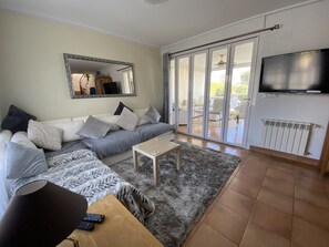Lounge with bifold doors to garden room
