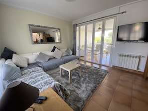Lounge with bifold doors to garden room