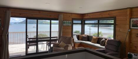 An open plan living area and kitchen looks out to the Whangārei harbour. 