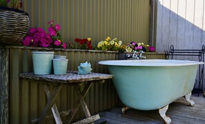 Outdoor bath with flower beds alongside