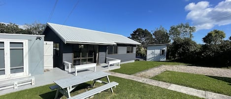 Blue skies and large flat front lawn.