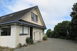 Side of Kotare House showing entrance door