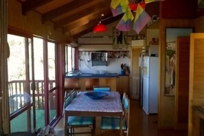 Dinning and Kitchen area.  Master bedroom off to the right. Front deck to left.