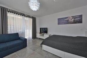 A cozy bedroom area with a double bed, bedside table, and soft lighting creating a warm ambiance.
