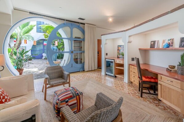 Unique seating area with pops of color and a large floor to ceiling sliding window!