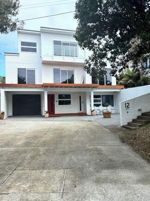 Looking onto house from road showing Apartment and parking area