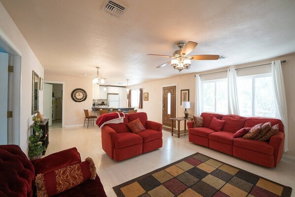 Comfortable couch and love seat with lots of throw pillows.