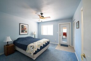 Primary bedroom offers privacy as well as access to the back yard. Walk-in closet is an added bonus