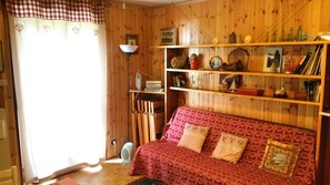 Living room. On left door to the terrace, on right a double sofa bed