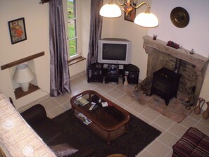 Lounge with log fire and vaulted ceiling

