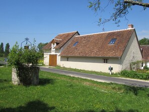 Facade on a quiet rural road that goes across the property