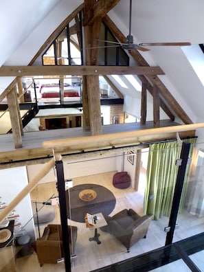 View of the living room from the bedroom on a mezzanine under the rooftop