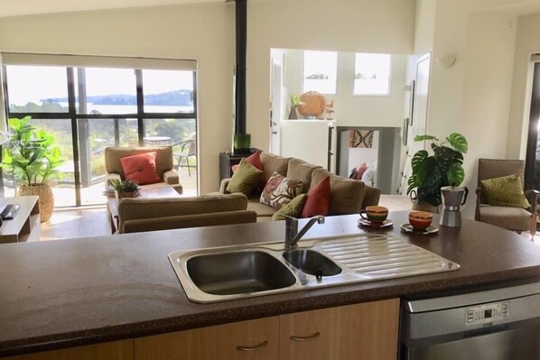 Kitchen over looking living and outlook back to Auckland city