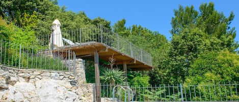 The beautiful private heated pool with sun terrace and dining terraces above