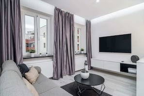 Living room with fold out sofa bed and double bed, dining area and tv