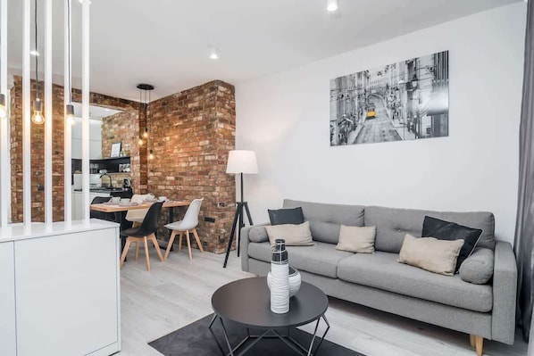 Living room with fold out sofa bed and double bed, dining area and tv