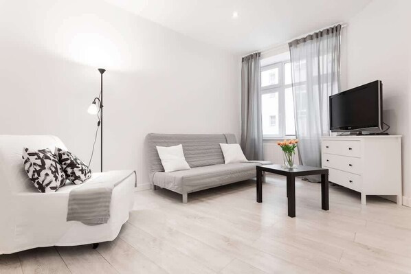 Living room with a comfortable sofa and TV. 