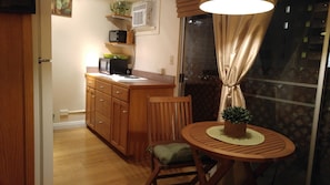 Dining table, kitchen with 2 burner stove, microwave, toaster oven