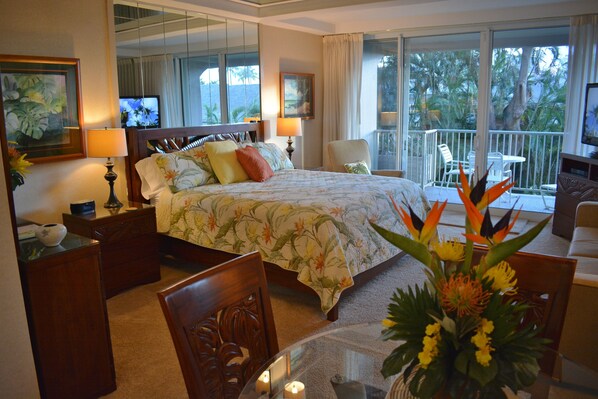 View looking  across dining area into bedroom area with lanai in the background.