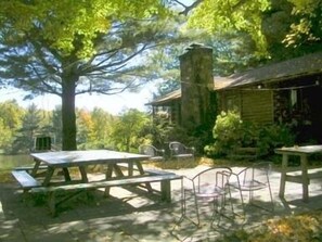 Outdoor dining area at side of cabin overlooks your lake