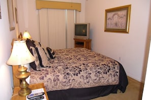Master bedroom, king bed, sliding glass door to balcony