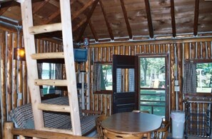 interior of front of cabin, fully equipped kitchen on right, not pictured