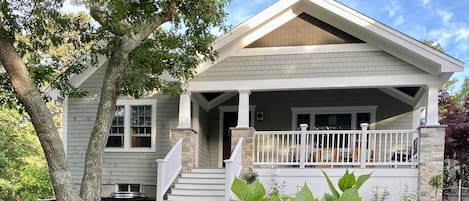 Front of house, yard, covered porch, sitting area