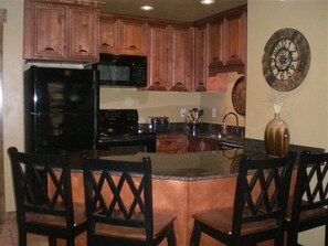 Remodeled kitchen including granite counter tops and custom cabinets