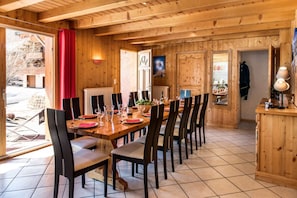 Bright living room with acces to the south-terrace in Chalet Snow Paradise in le Bettaix