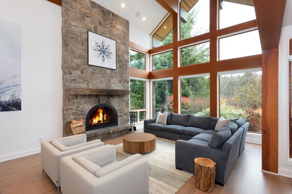 Formal living room featuring a wood-burning fire and entertainment system with surround sound