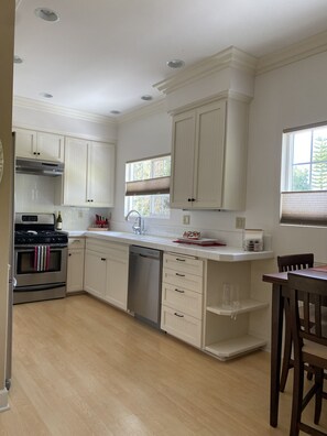 Spacious Full Kitchen with tree top window views 