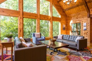 Living room with large floor to ceiling windows, plenty of natural light to enjoy!