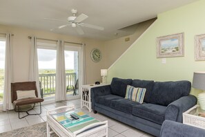 Comfortable living area featuring a queen-size sleeper sofa and beautiful beach view